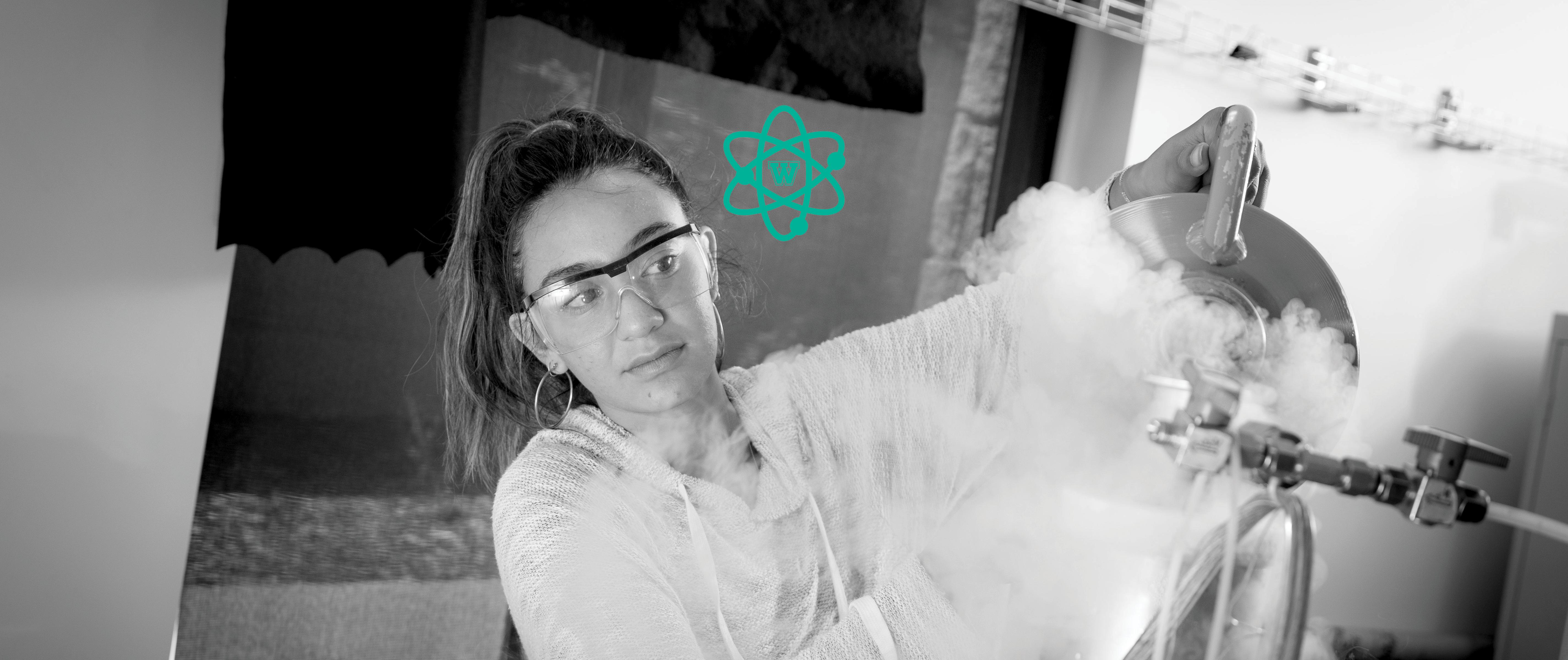 黑色的 & white image of female student wearing safety goggles working in lab; Westmont 阀杆 icon above.